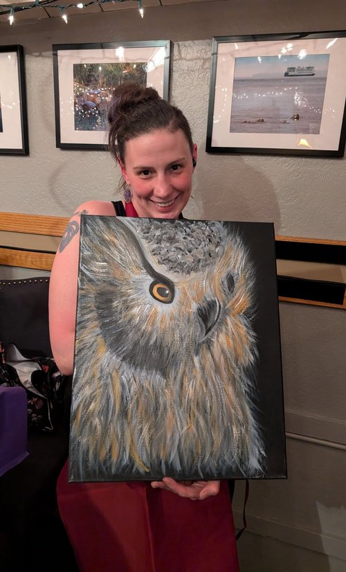 Guest holding an owl painting