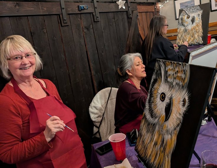 Guest standing proudly with her owl painting